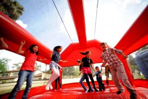 a group of kids jumping on a bouncy castle